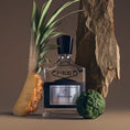 Load image into Gallery viewer, Aventus by Creed, bottle with raw materials

